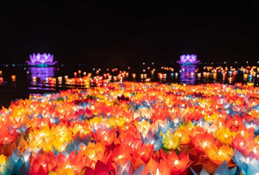 Floating colored lanterns and garlands on river
