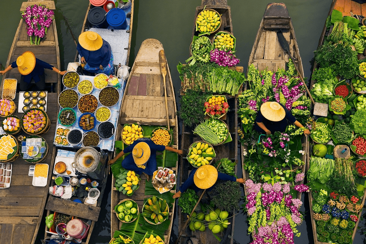 Floating market boats in Mekong Delta with vendors selling fresh produce